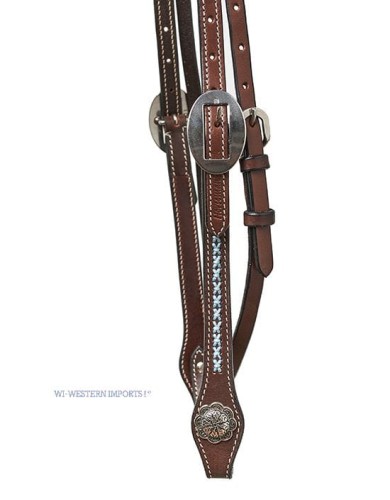 Zbliżenie policzka ogłowia Horseman's Tack — owalna srebrna concha przy klamrze, niebieski haft cross na ciemnej espresso skórze, kwiatowa concha Spanish-cut — HorsePassion.pl