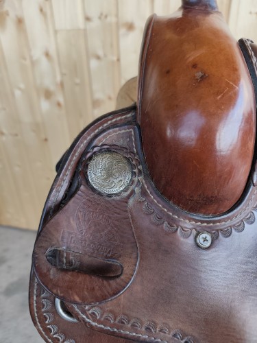 Stempel Garland Saddlery Finest Quality — antyczna concha na połce siodła western