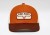 Czapka Kimes Ranch Rolling Trucker — haftowana naszywka twill patch Kimes Ranch z logo longhorn, burnt orange front